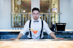 Barman preparing a pineapple and strawberry cocktail