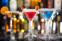 Cocktail with ice vapor on bar desk